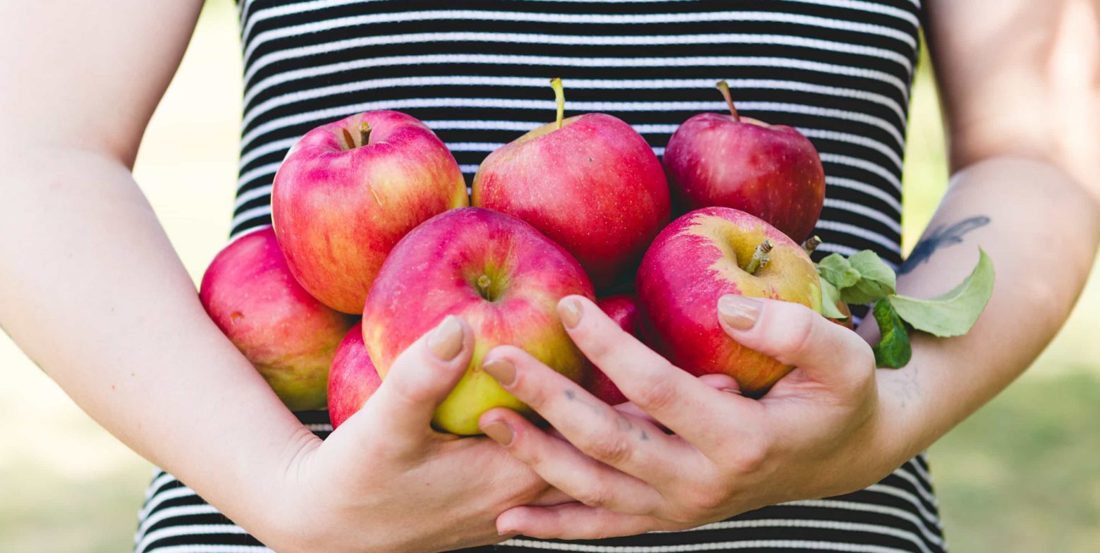 Woman holding a bunch of fresh apples