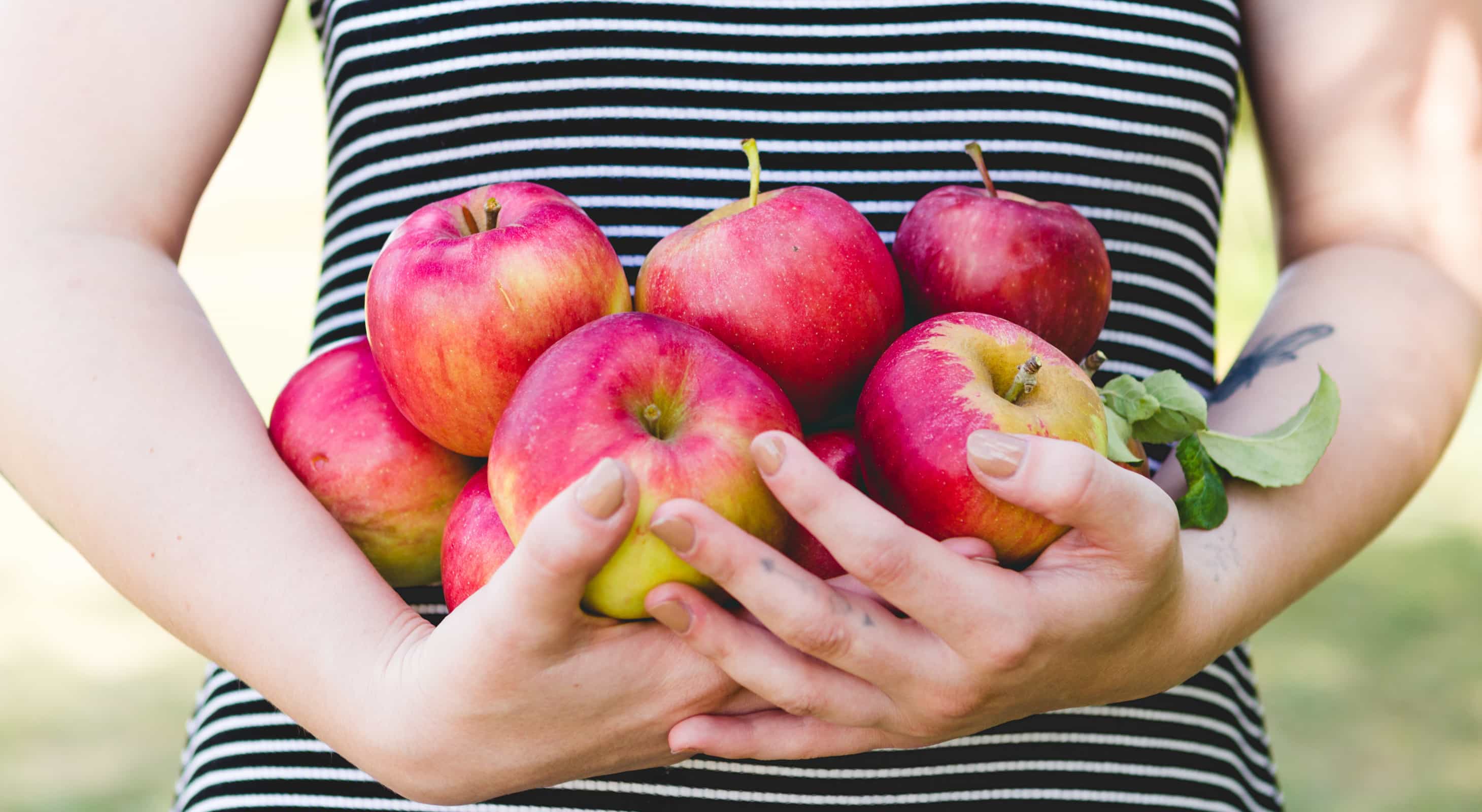 Woman holding a bunch of fresh apples