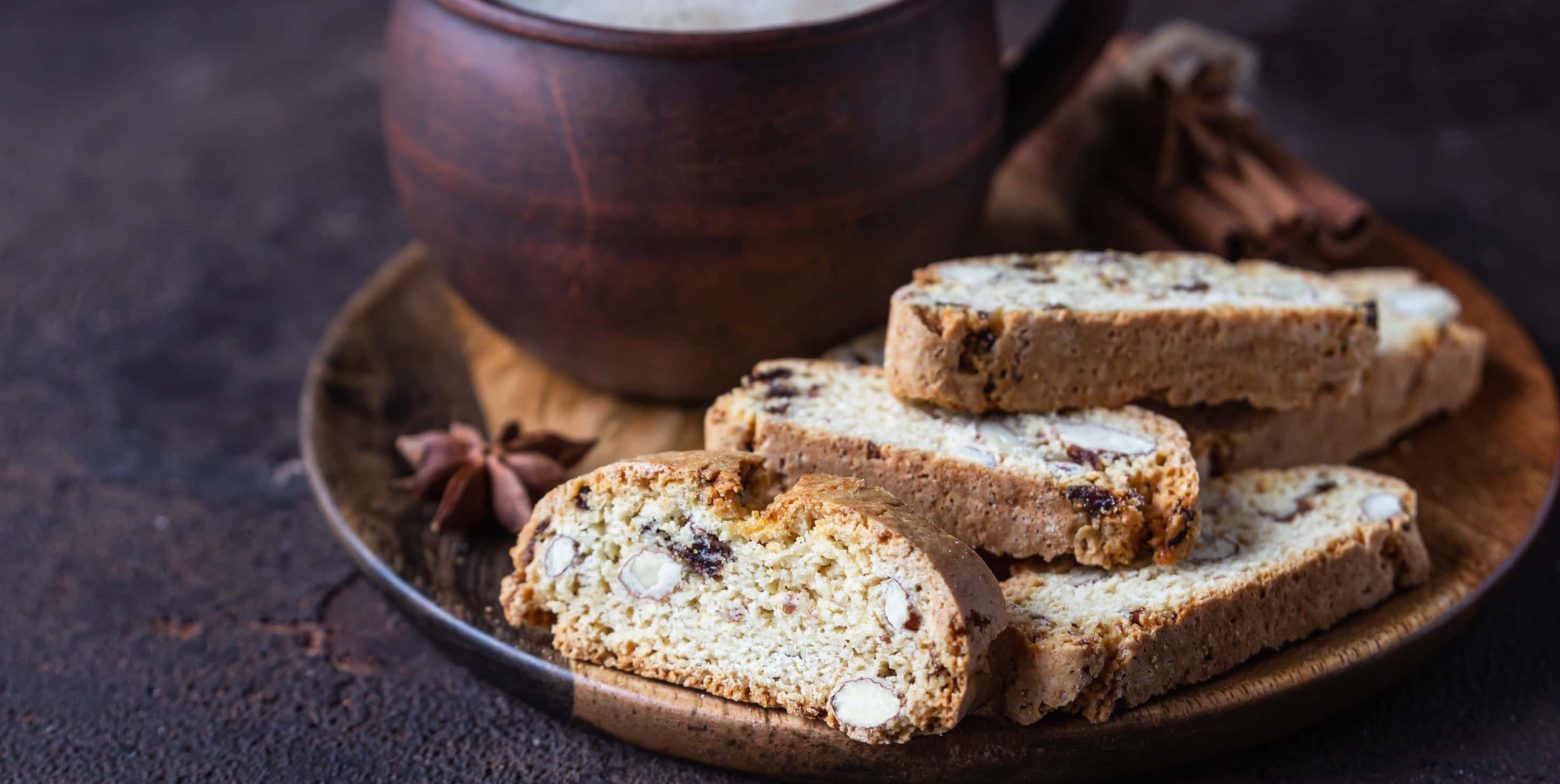 Almond biscotti on a wooden plate served with coffee