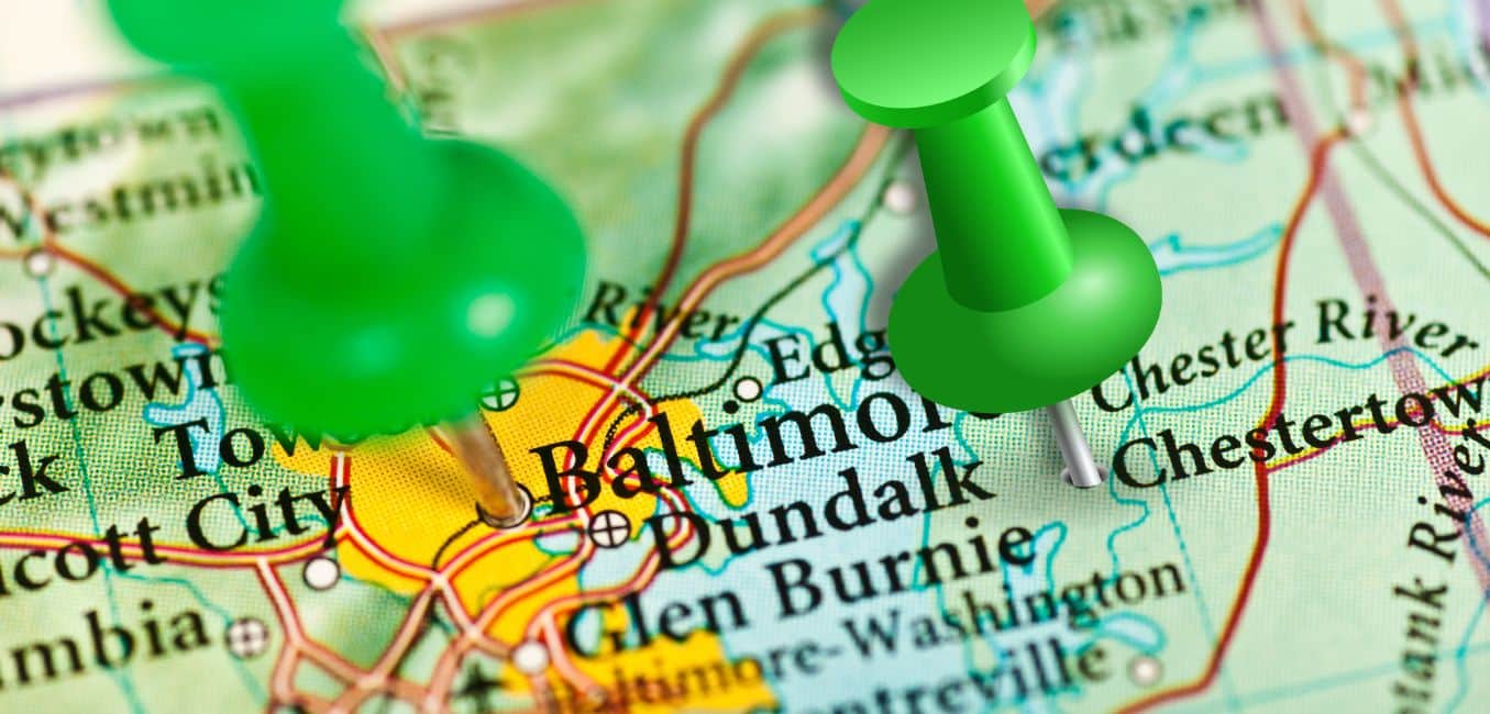 closeup of maryland map with green push pin on baltimore and one on chestertown