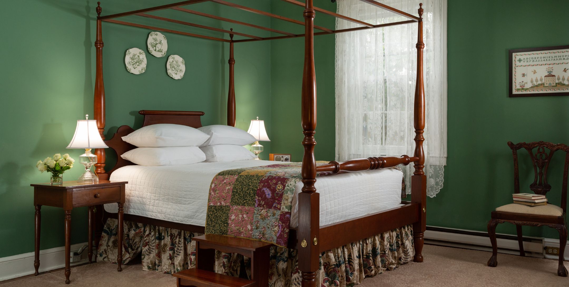 Green Room with green walls, lace curtains, four poster bed and carpeted rug