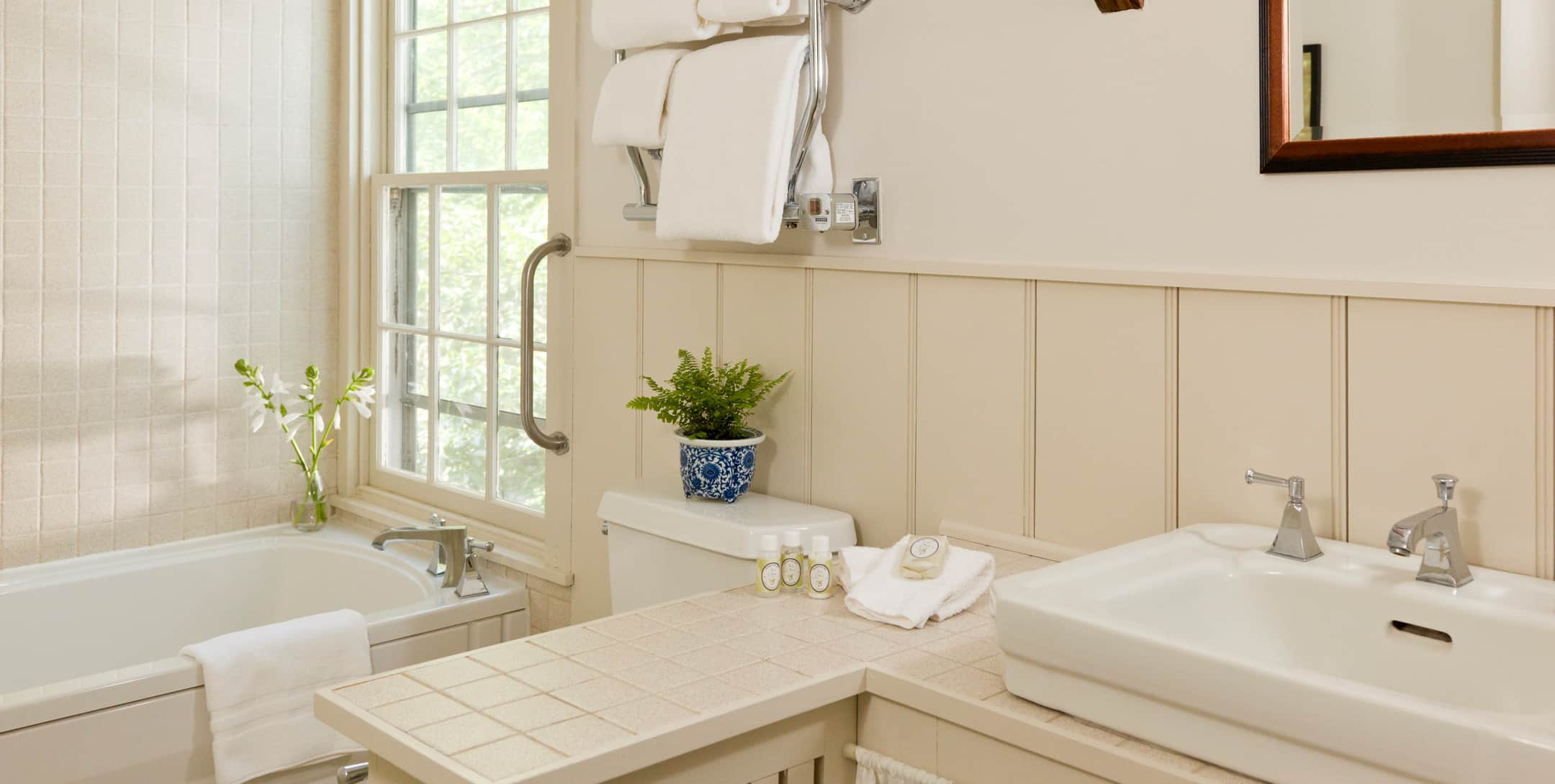 Bathroom with white walls and tile in the Emory Suite at Brampton Inn