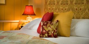 Pillows on a king bed in the Poppy's Retreat room at Brampton Inn