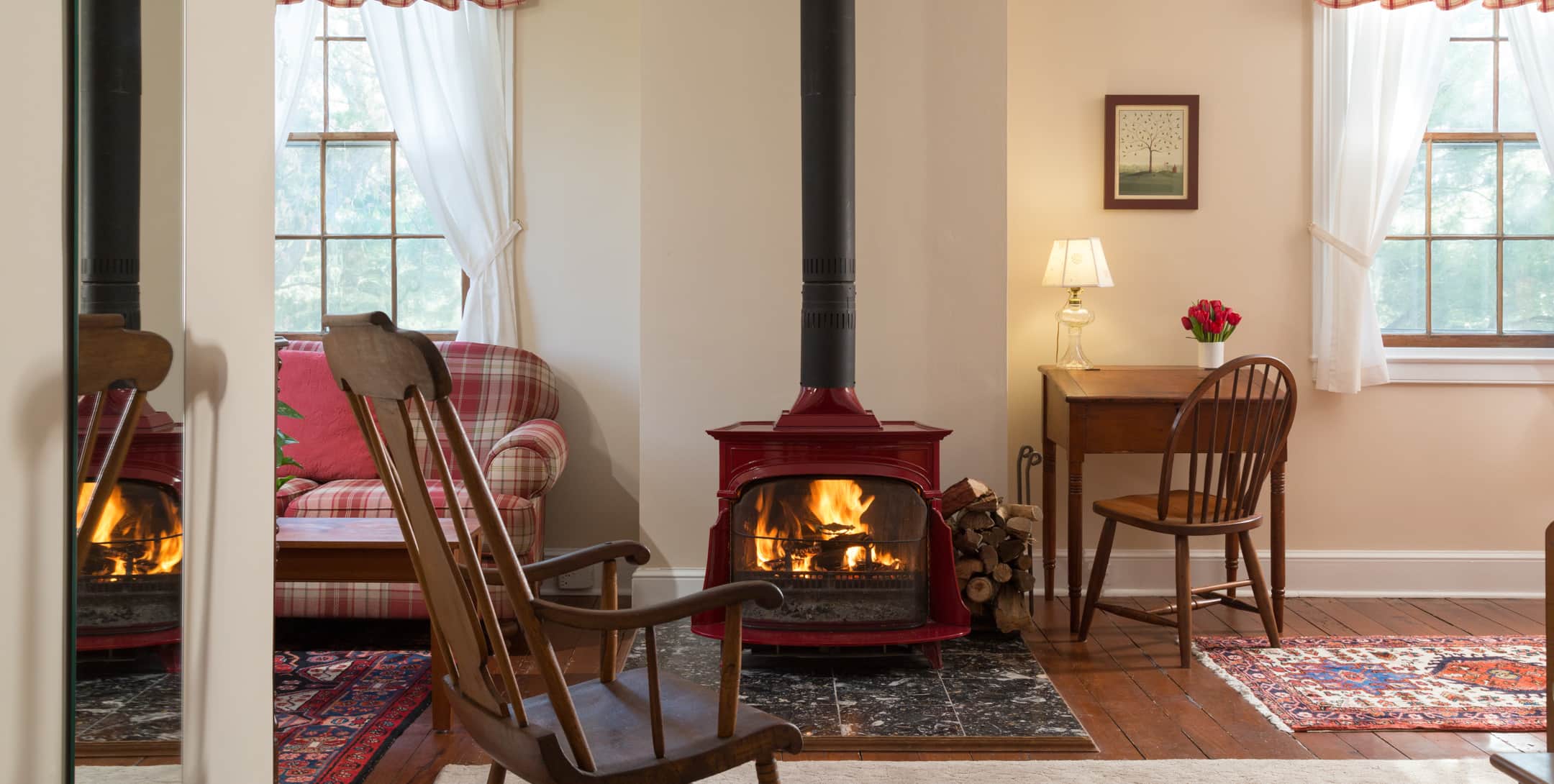 Red Room at Brampton Inn with a sitting area and a wood-burning stove and a writing desk