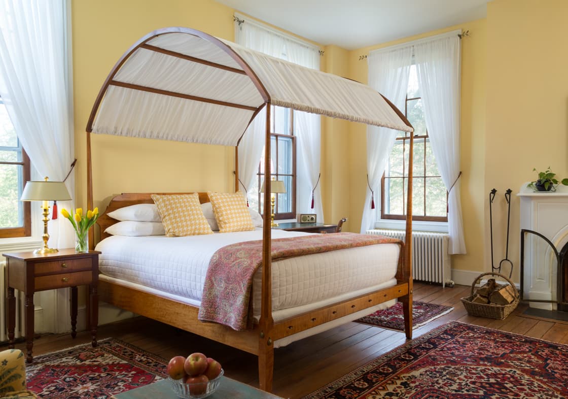 The Yellow Room at Brampton Inn with a queen bed and fireplace