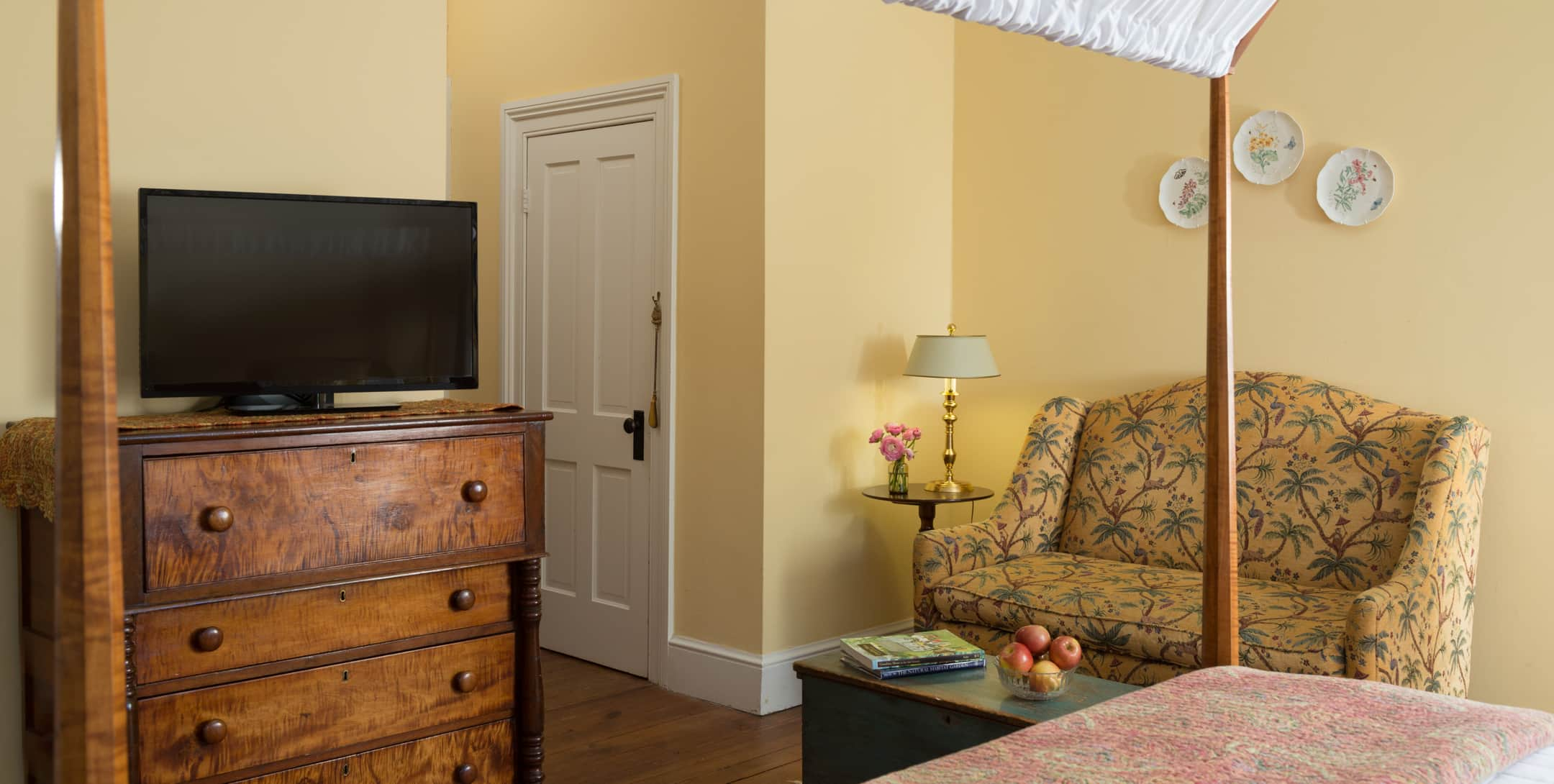 Flatscreen TV on a dresser in the Yellow Room at Brampton 1860