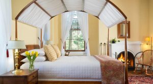 Yellow Room canopy bed and fireplace