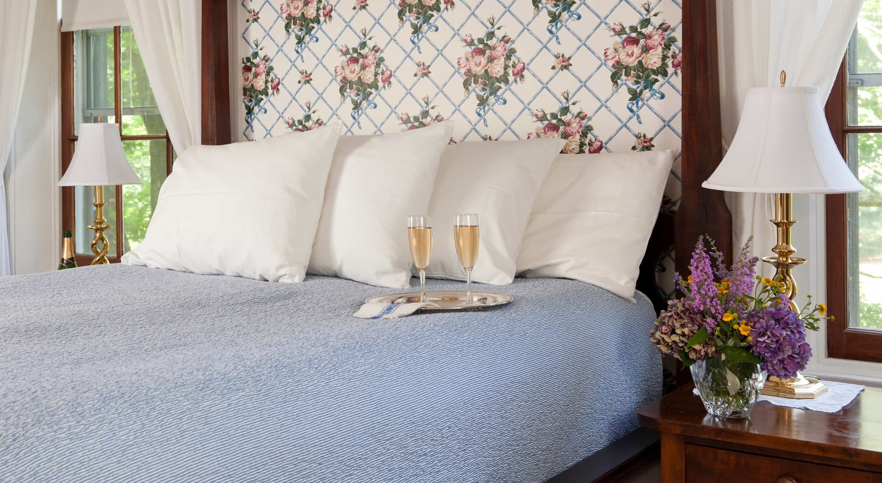 Wine glasses on a bed in the blue room