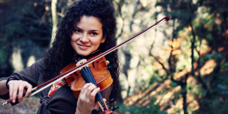 Woman playing violin at outdoor event
