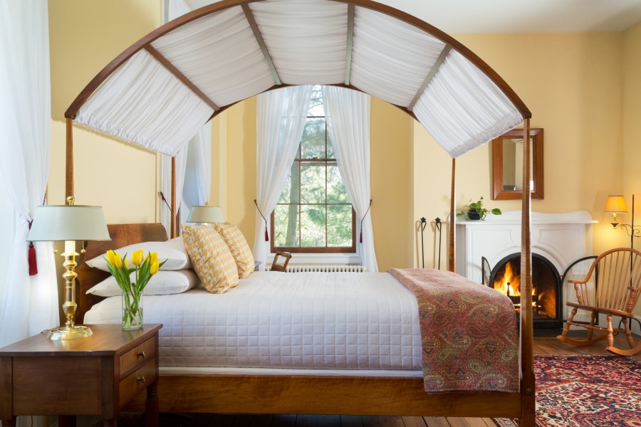 Four-poster bed and fireplace at Maryland bed and breakfast