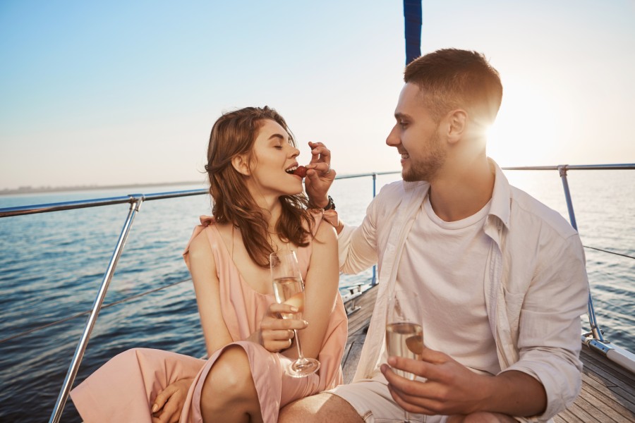 Couple eating strawberries while sailing in Maryland