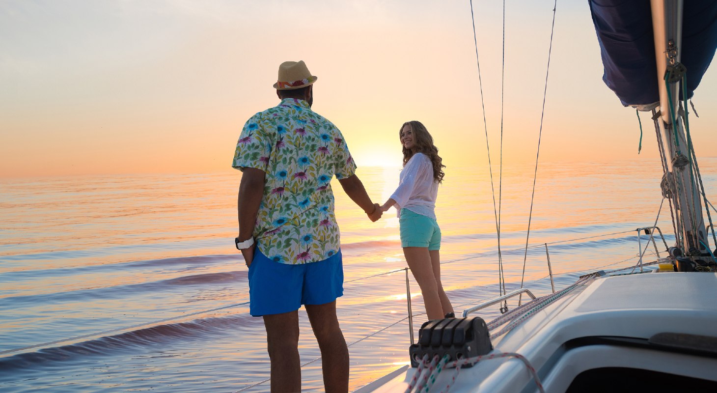 Couple holding hands after sailing in Maryland at sunset