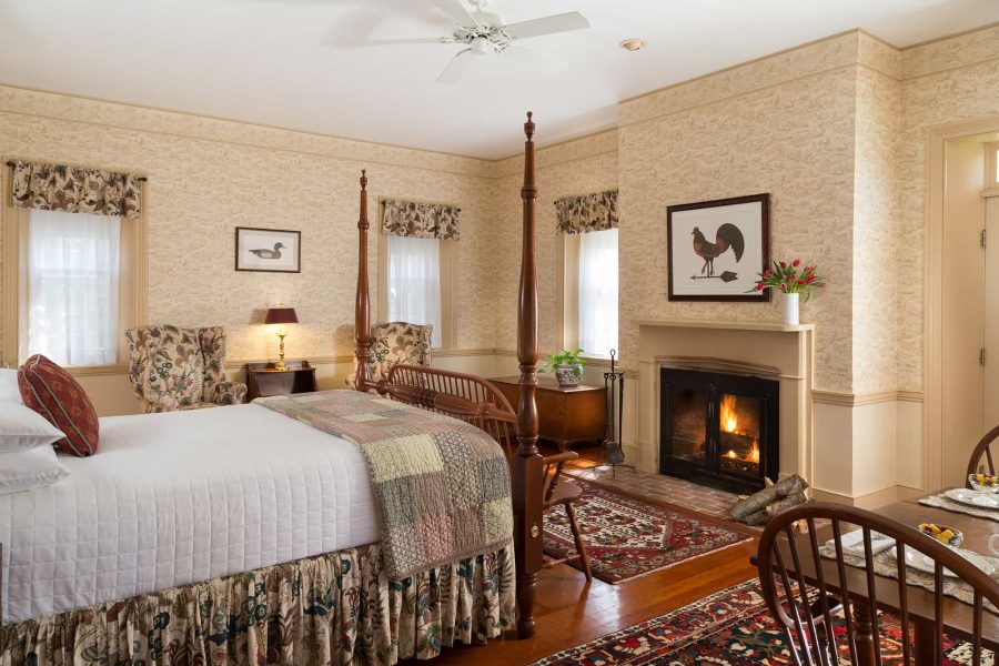 a room at brampton inn with a bed and fireplace