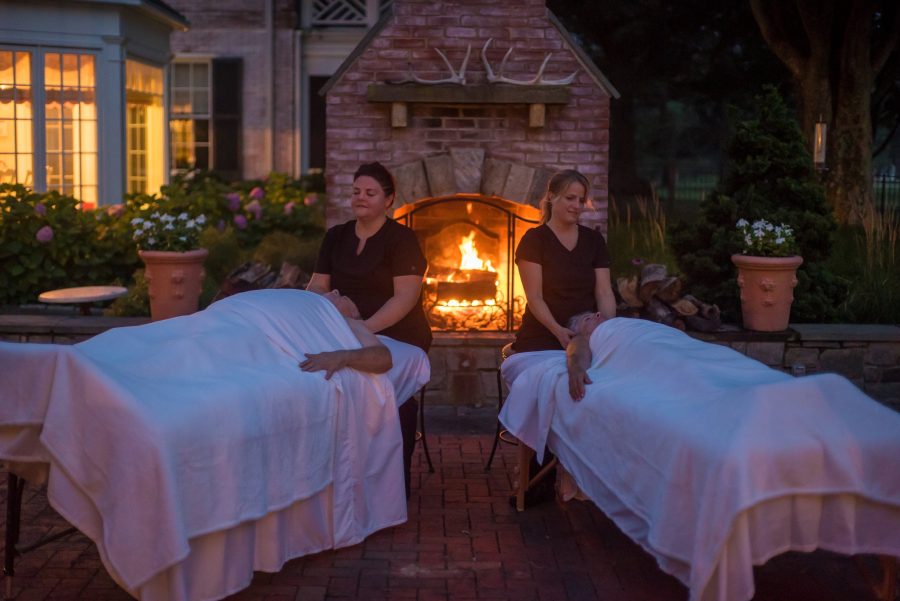 Couple enjoying outdoor massage with fireplace