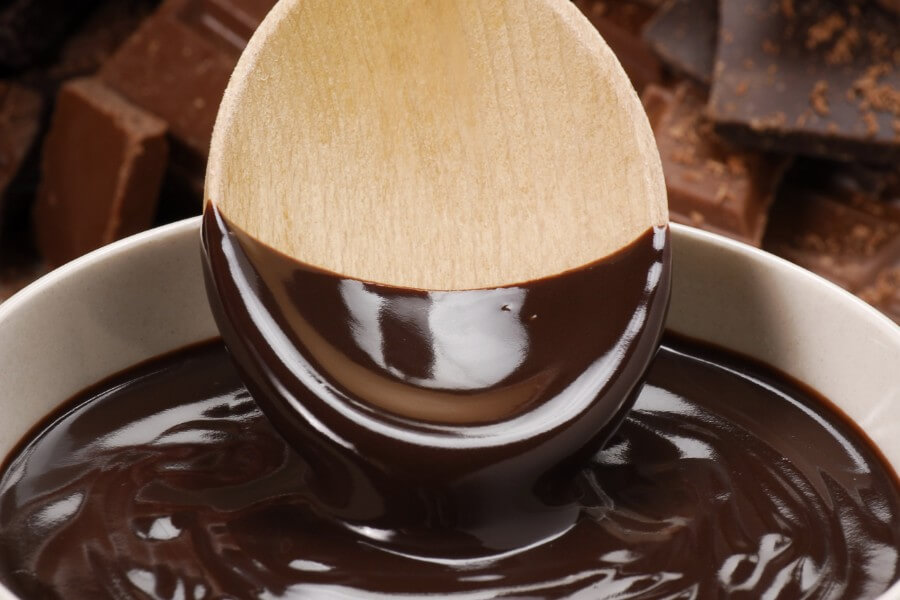 wooden spoon dipped in melted chocolate