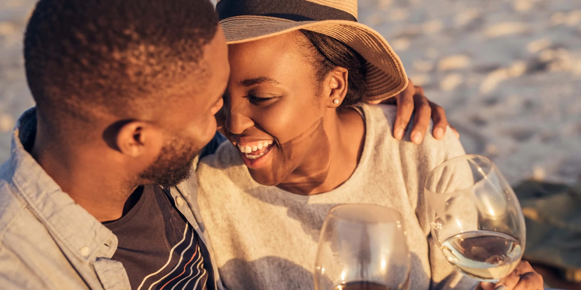 romantic couple on beach drinking wine