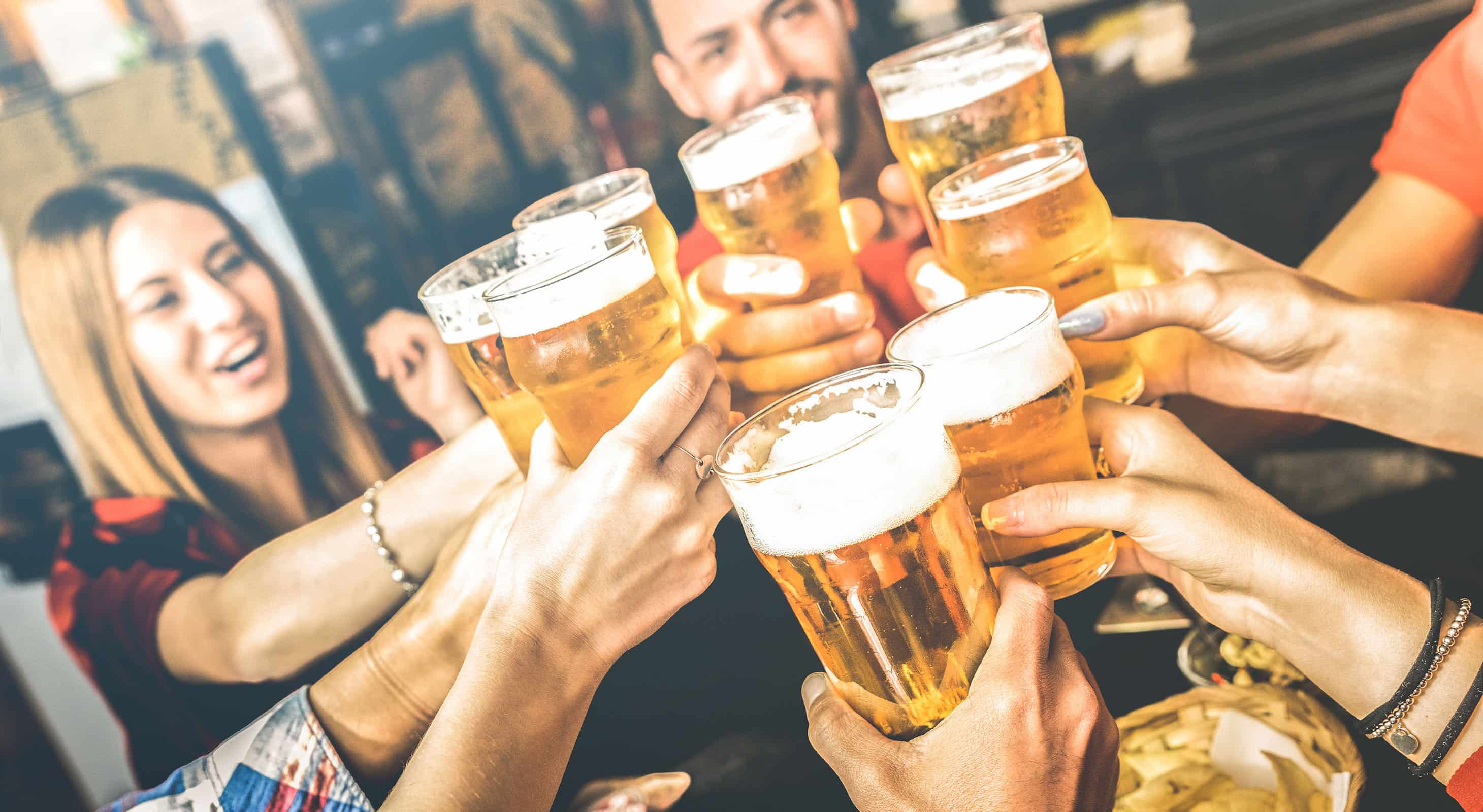 Group of friends toast beers at local festival