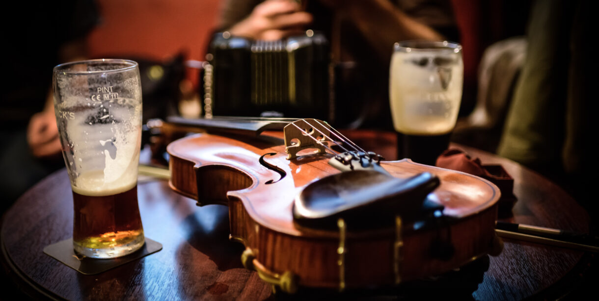Violin on table with glass of Guinness beer