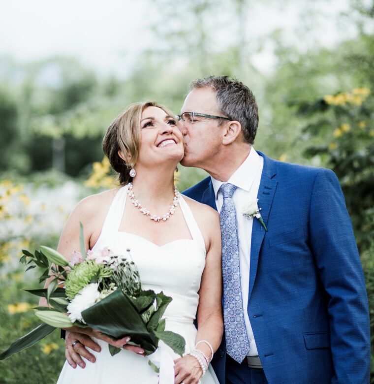 Wedding Couple - groom kissing new bride's cheek.