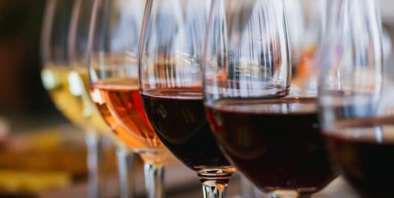 a flight of wines from deep red to white