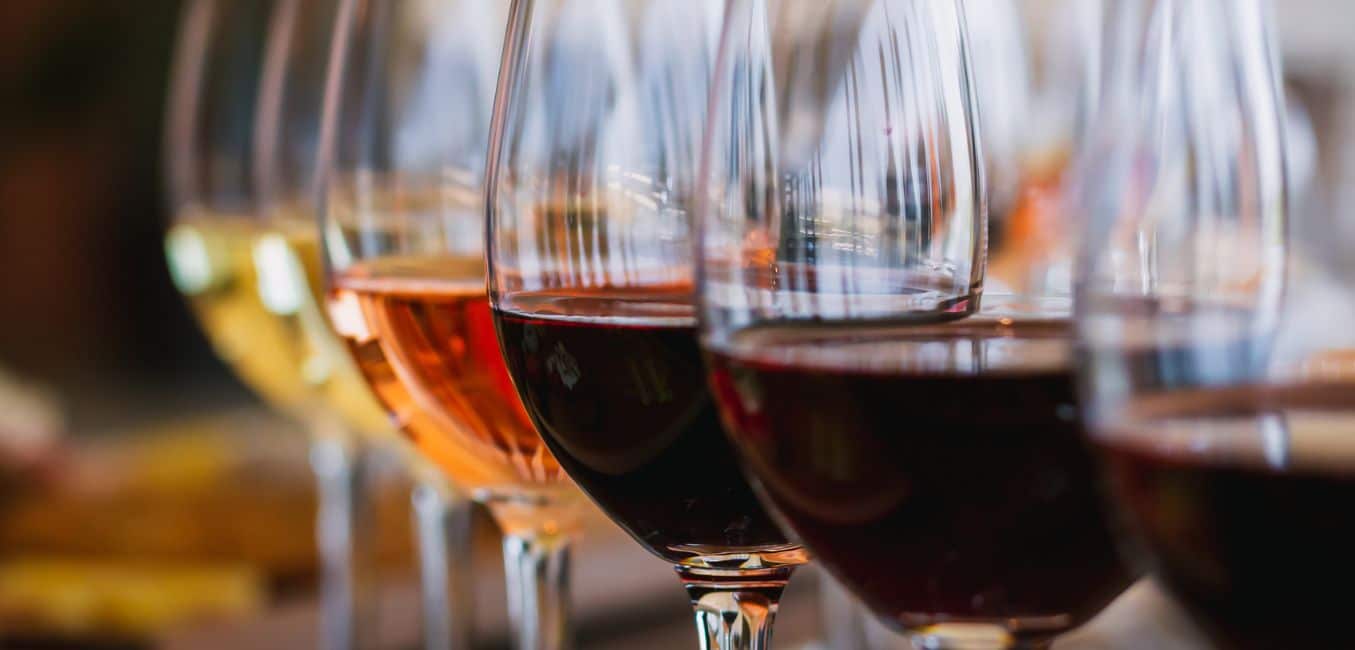 a flight of wines from deep red to white
