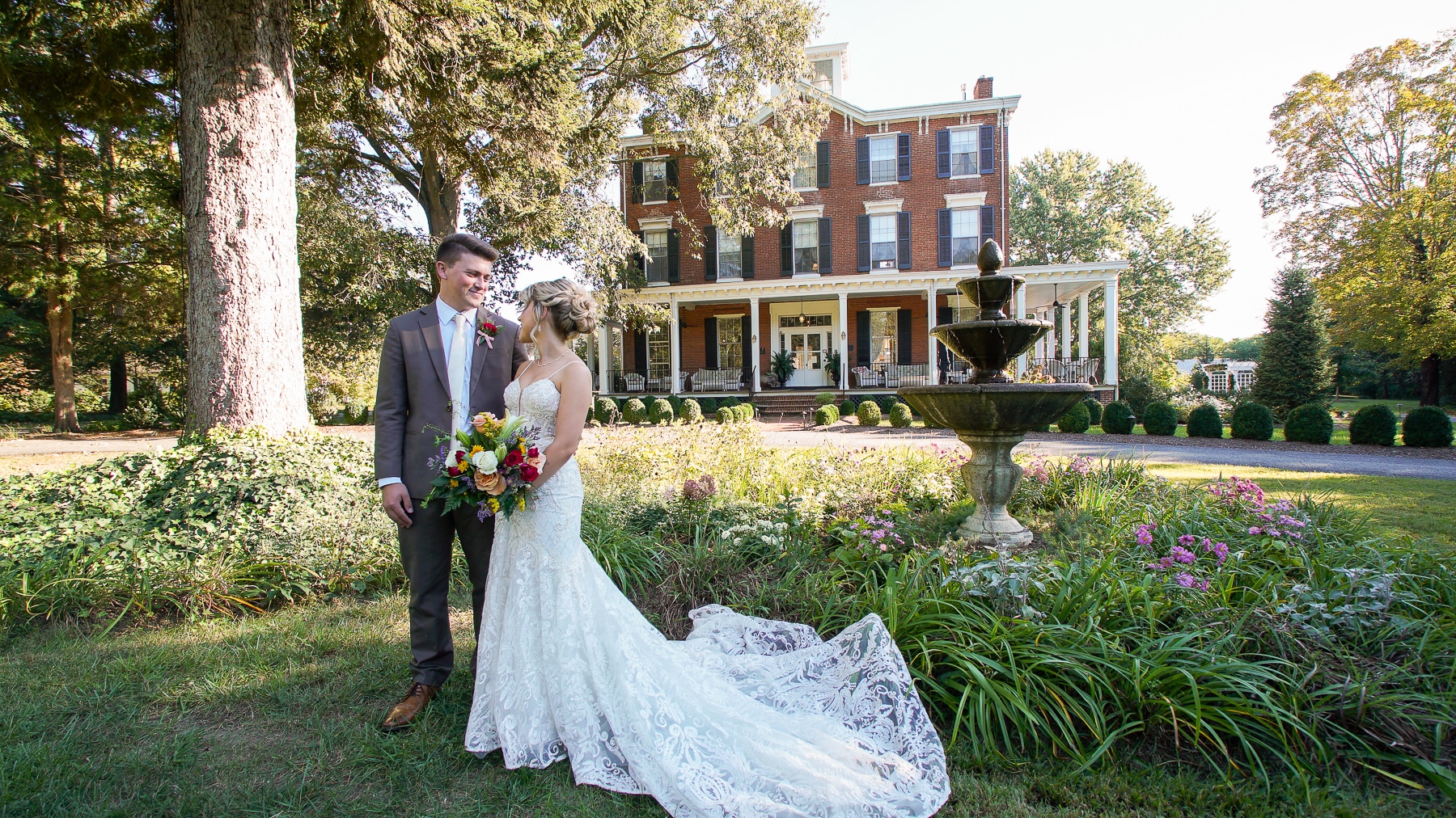 Bride and Groom in front lawn of Brampton 1860 with manor house in background