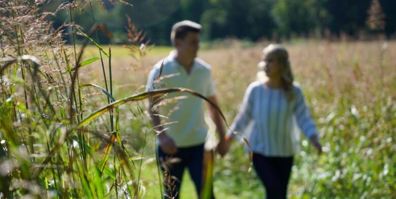 couple holding hands and relaxing on a walk through brampton 1860 property trails