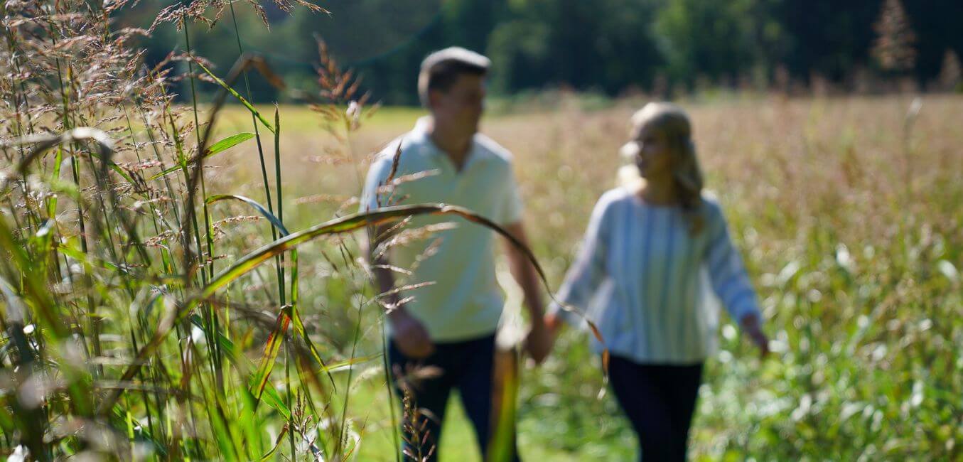 couple holding hands and relaxing on a walk through brampton 1860 property trails