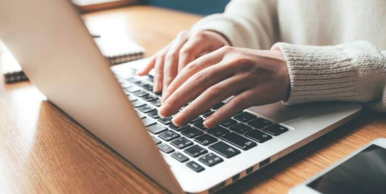 woman working on a laptop at a quiet desk during a maryland workcation