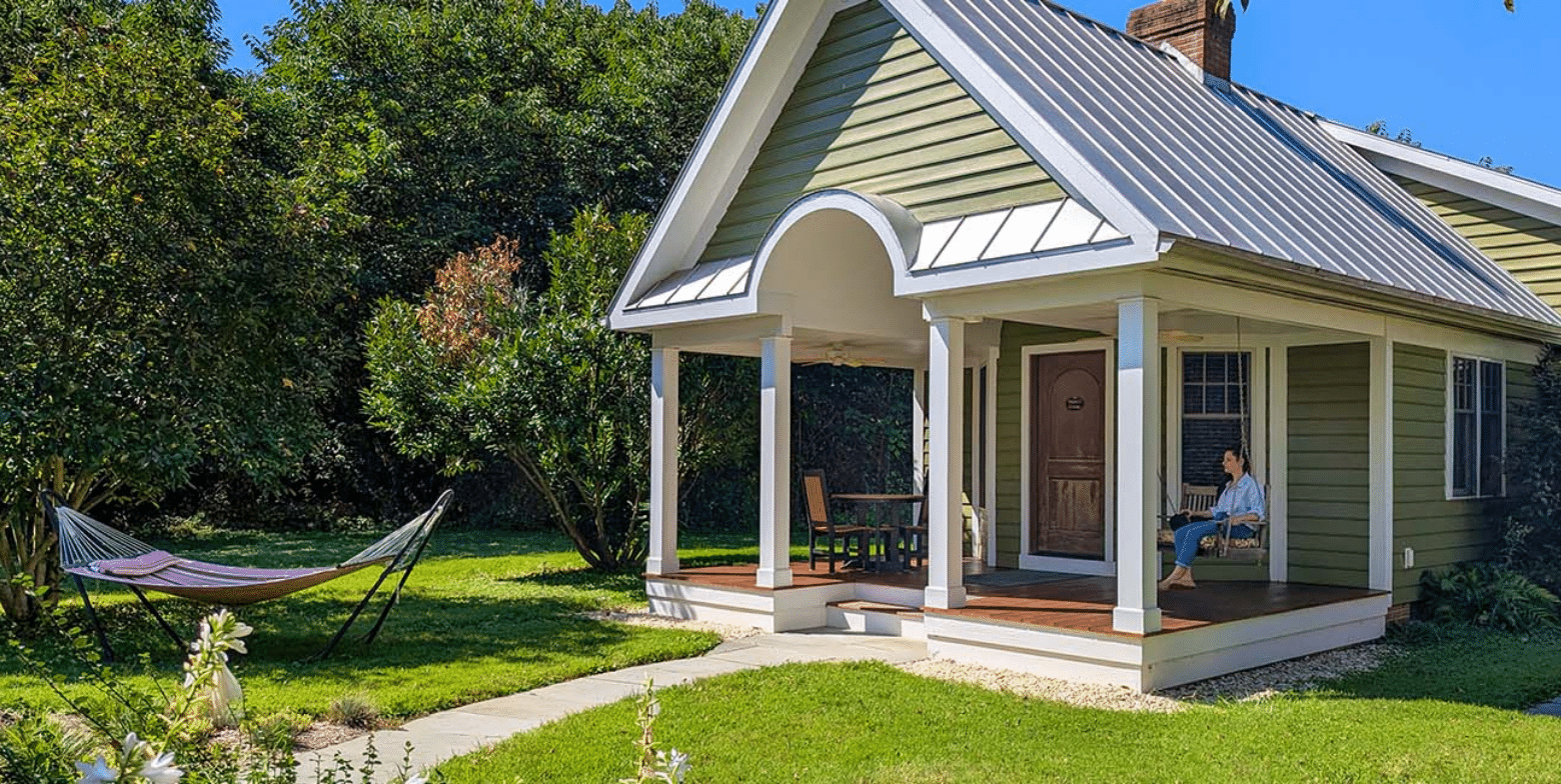 Front porch of Marley's cottage and hammock on the front lawn on a sunny day