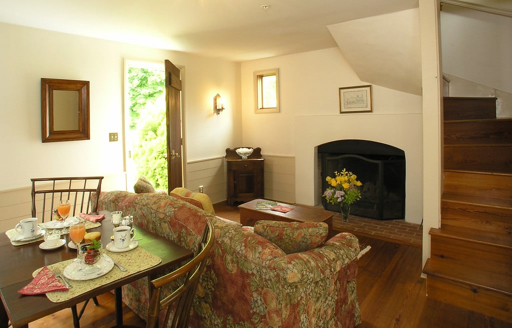 dining table and living room with fireplace in the Fairy Hill Suite